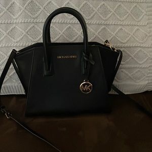 Small black leather cross body.. used twice. Excellent condition.